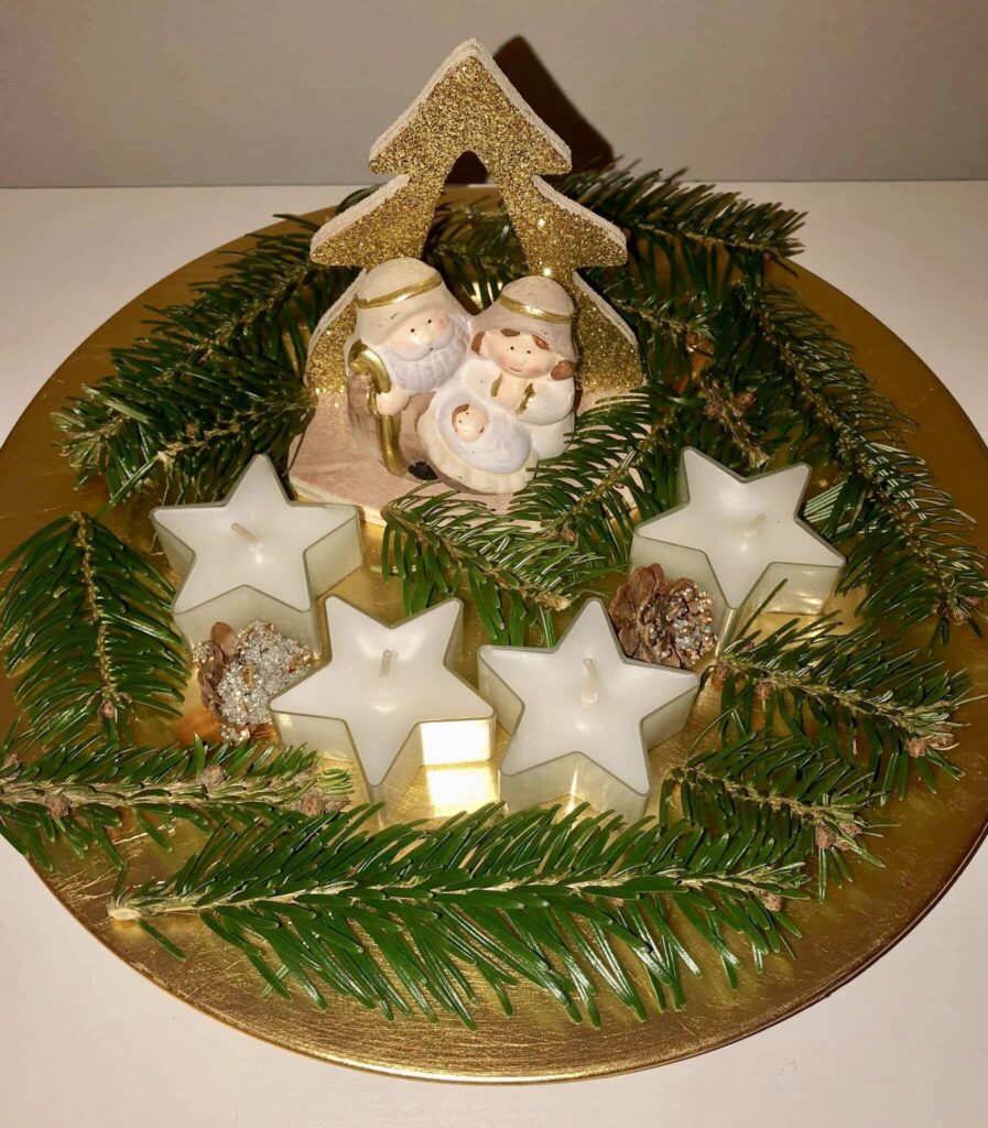 Homemade Advent Wreath with 4 candles and a manger.