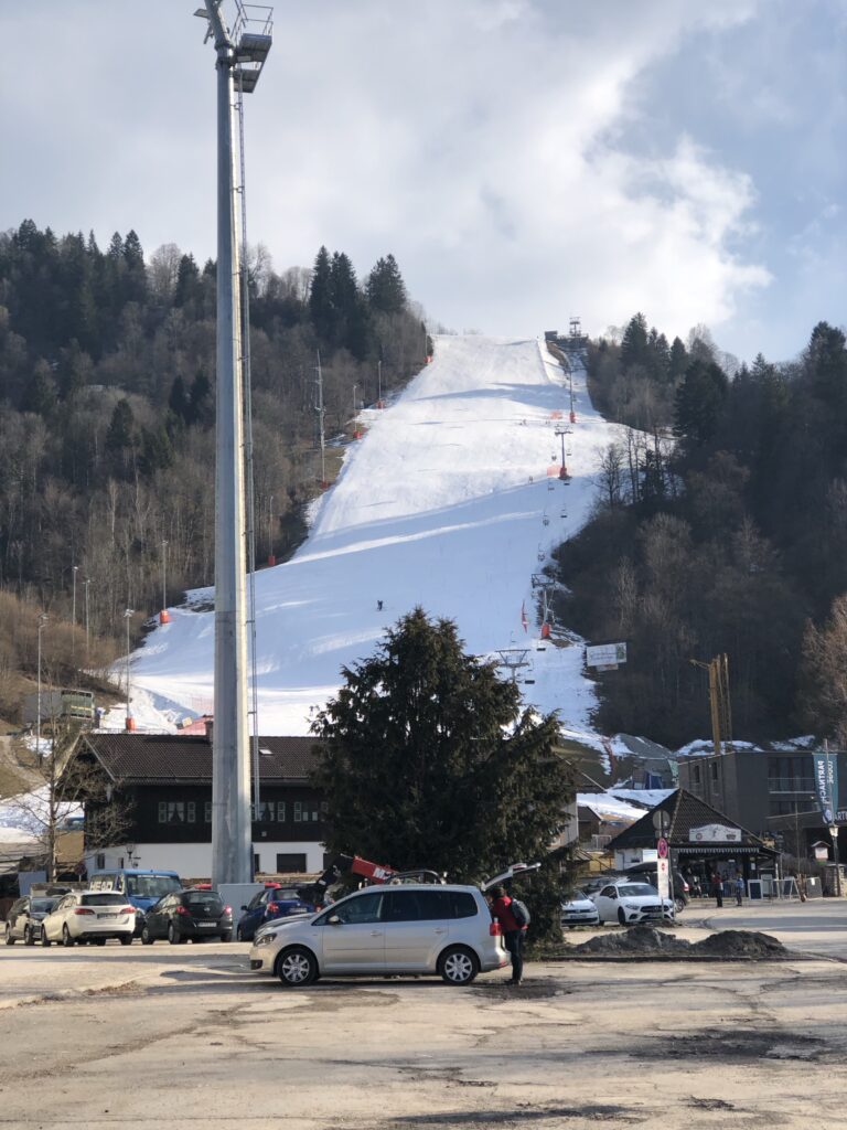 The Olympic Ski Stadium covered in snow, next to the parking lot for the Partnachklamm in Germany