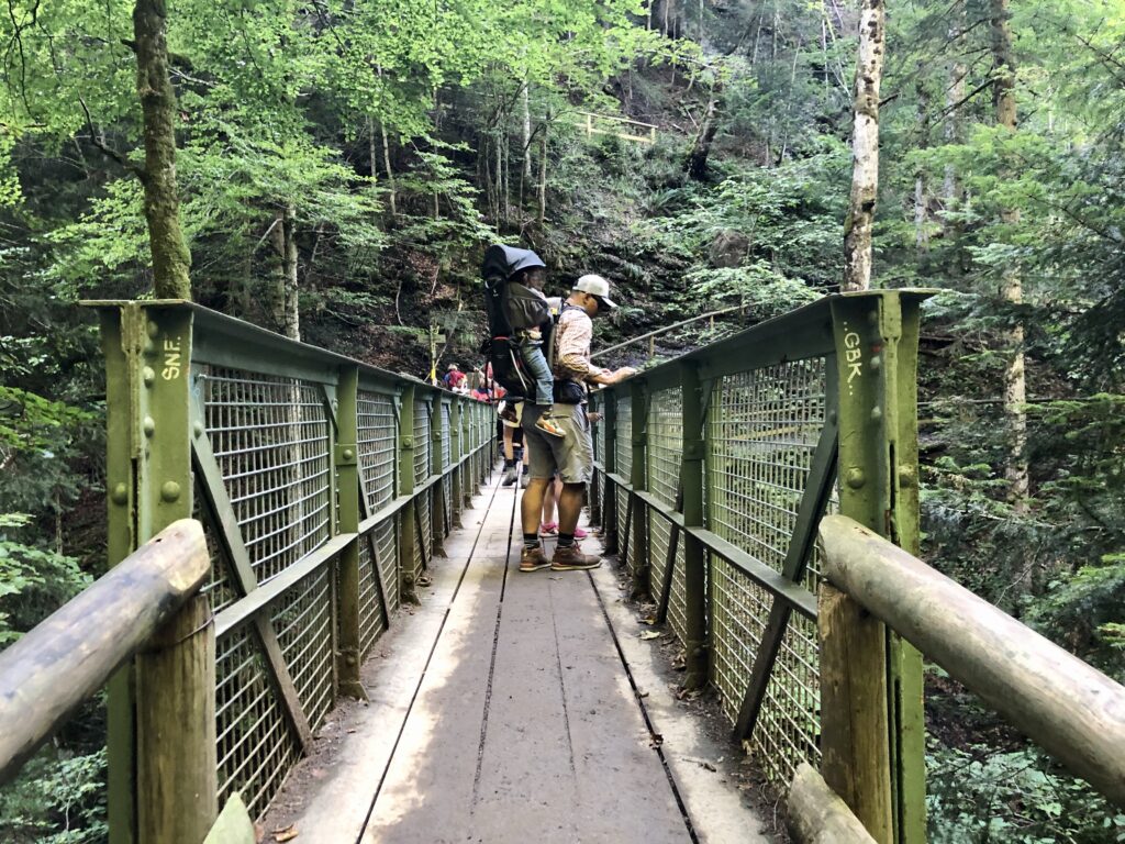 Families crossing the iron bridge during a hike around the Partnach Gorge in Germany 