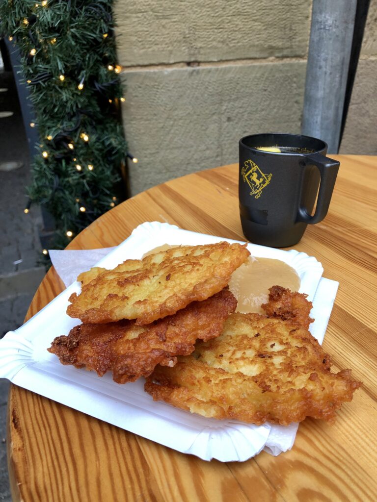 kartoffel puffers at the Stuttgart Christms market with a mug of glühwein