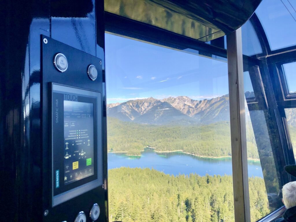 Mountain lake views as a cable car ascends to the top of Germany's highest mountain. the Zugspitze. 