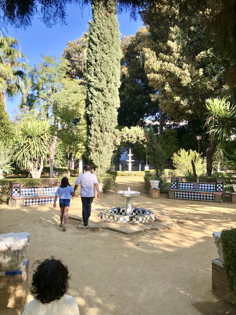 Walking by a fountain in Jardines de Murillo (Murillo Gardens) in Sevilla, Spain 