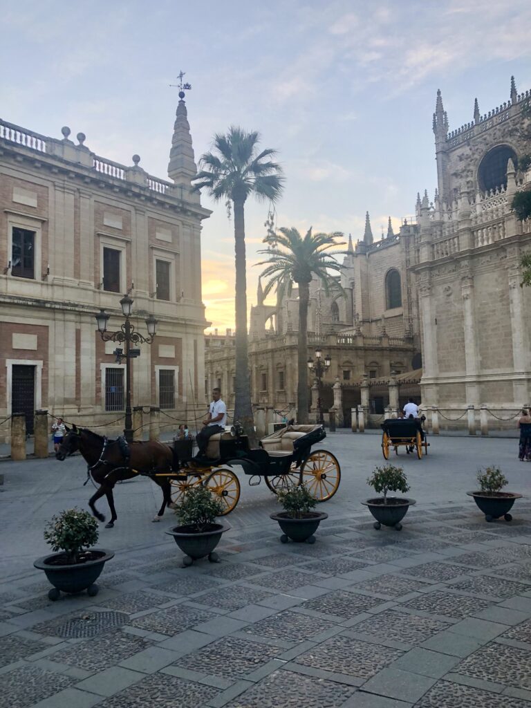 Sunset and a horse-drawn carriage in historic Sevilla, Spain